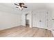 Bedroom featuring wood-look flooring, a ceiling fan, and a spacious walk-in closet at 1718 26Th Ave. N, North Myrtle Beach, SC 29582