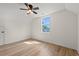 Bright bedroom with wood-look floors, ceiling fan, and a window providing ample natural light at 1718 26Th Ave. N, North Myrtle Beach, SC 29582