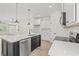 Bright kitchen featuring an island with seating, stainless steel appliances, and an open layout at 1718 26Th Ave. N, North Myrtle Beach, SC 29582