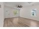 Inviting living room featuring wood-look floors, a modern ceiling fan, and lots of natural light at 1718 26Th Ave. N, North Myrtle Beach, SC 29582