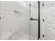 Modern bathroom shower with white marble tiling, glass door, and shower niche at 1718 26Th Ave. N, North Myrtle Beach, SC 29582