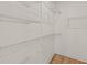 Walk-in closet with white wire shelving and wood-look laminate floors at 1718 26Th Ave. N, North Myrtle Beach, SC 29582