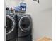 Modern laundry room with front-load washer and dryer and storage shelves at 181 Ella Kinley Circle # 305, Myrtle Beach, SC 29588