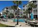 Community pool with lounge chairs surrounded by palm trees at 181 Ella Kinley Circle # 305, Myrtle Beach, SC 29588