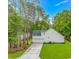 Rear exterior view of the house with a well-maintained lawn and a two car garage at 19 Coventry Pl., Pawleys Island, SC 29585