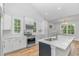 Bright kitchen with white cabinets, stainless steel appliances, quartz countertops, and a large island at 19 Coventry Pl., Pawleys Island, SC 29585