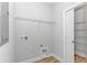Bright laundry room with wood-look floors, wire shelving, and closet with ample storage space at 19 Coventry Pl., Pawleys Island, SC 29585