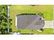 An aerial shot showing the home's roof, expansive lawn, and landscaping with a fenced border at 276 Whipple Run Loop, Myrtle Beach, SC 29588