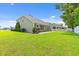 The well-maintained backyard features a lush lawn and a view of the back of the two-story home at 276 Whipple Run Loop, Myrtle Beach, SC 29588