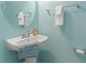 Charming half bathroom with pedestal sink, round mirror, and light turquoise walls at 276 Whipple Run Loop, Myrtle Beach, SC 29588