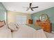 A traditional bedroom with a ceiling fan, carpeted floor, and neutral decor at 276 Whipple Run Loop, Myrtle Beach, SC 29588