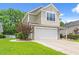 A charming two-story home features a large garage, neutral siding, and a well-manicured lawn at 276 Whipple Run Loop, Myrtle Beach, SC 29588