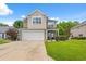 A charming two-story home featuring a large garage, neutral siding, and a covered front porch at 276 Whipple Run Loop, Myrtle Beach, SC 29588