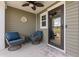 A covered front porch with comfortable seating and a ceiling fan at 276 Whipple Run Loop, Myrtle Beach, SC 29588