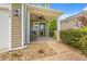 A charming covered front porch with comfortable seating and attractive landscaping at 276 Whipple Run Loop, Myrtle Beach, SC 29588