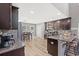 Open kitchen showcasing dark wood cabinets, granite countertops, and stainless steel appliances at 276 Whipple Run Loop, Myrtle Beach, SC 29588