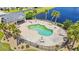 Aerial view of a community pool with a unique shape surrounded by lounge chairs and palm trees at 276 Whipple Run Loop, Myrtle Beach, SC 29588