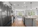 Modern kitchen with granite countertops, stainless steel appliances, and a seamless transition to the dining area at 277 Splendor Circle, Murrells Inlet, SC 29576