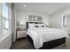 Tranquil bedroom with a large window, bedside table, and elegant bedding at 2828 Rowyn St., Longs, SC 29568
