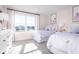 A well-lit, comfortable bedroom with two twin beds, large windows, and light-colored walls and carpet at 2828 Rowyn St., Longs, SC 29568