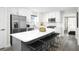 Stylish kitchen with white cabinets, stainless steel appliances, island with seating, and lots of light at 2828 Rowyn St., Longs, SC 29568