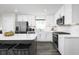 Modern kitchen featuring white cabinets, stainless steel appliances, and an island with bar stools at 2828 Rowyn St., Longs, SC 29568