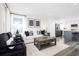 Bright living room with a white sofa, plush chairs, and an open floor plan at 2828 Rowyn St., Longs, SC 29568