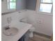 Bright bathroom featuring a white vanity, tiled walls, and window for natural light at 3110 Pinewood Dr., Loris, SC 29569