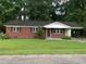 Charming one-story brick home with well-maintained lawn and mature trees at 3110 Pinewood Dr., Loris, SC 29569