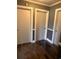 Hallway with hardwood floors, gray walls and three doors at 3110 Pinewood Dr., Loris, SC 29569