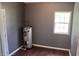Water heater in a room with a window, hardwood floor and gray walls at 3110 Pinewood Dr., Loris, SC 29569