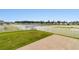 Landscaped backyard features lush grass and a white picket fence surrounding a tranquil pond at 347 Leste Rd., Myrtle Beach, SC 29588