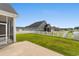 Spacious backyard with a white picket fence, lawn, and access to the screened-in porch at 347 Leste Rd., Myrtle Beach, SC 29588