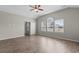 A sunny bedroom boasts wood-look floors, vaulted ceiling, and large window at 347 Leste Rd., Myrtle Beach, SC 29588