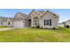 Charming home exterior featuring a landscaped yard, attached garage, and brick accents at 347 Leste Rd., Myrtle Beach, SC 29588