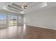 Spacious living room featuring a tray ceiling, ceiling fan, and sliding glass doors to the backyard at 347 Leste Rd., Myrtle Beach, SC 29588