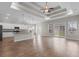 Open concept living room and kitchen area with tray ceiling, modern lighting, and hardwood floors at 347 Leste Rd., Myrtle Beach, SC 29588