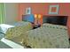 Cozy bedroom featuring two beds with palm tree patterned bedspreads and stylish wall art at 3500 N Ocean Blvd. # 701 702, North Myrtle Beach, SC 29582