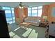 Sunny living room with ocean view, cozy furniture, and large windows for natural light at 3500 N Ocean Blvd. # 701 702, North Myrtle Beach, SC 29582