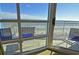 Balcony with ocean view and blue patio furniture at 3500 N Ocean Blvd. # 701 702, North Myrtle Beach, SC 29582