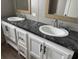 Double vanity featuring two white sinks, black marble countertops, and white cabinets at 364 Jamie Rd., Galivants Ferry, SC 29544