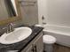 Bathroom with a white vanity sink, marble-look countertop, and a combination tub/shower at 364 Jamie Rd., Galivants Ferry, SC 29544