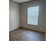 An empty bedroom with wood-look floors, and a window providing natural light at 364 Jamie Rd., Galivants Ferry, SC 29544