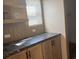 Featuring modern countertops and natural wood cabinetry, providing ample storage space and elegant style at 364 Jamie Rd., Galivants Ferry, SC 29544