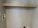 Laundry room with wall-mounted utility connections and an upper wooden shelf at 364 Jamie Rd., Galivants Ferry, SC 29544