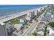 Aerial view of the beach, condos, homes, road, and parking, showing the oceanfront location at 4105 S Ocean Blvd. # 102, North Myrtle Beach, SC 29582