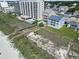 Aerial view showing the condo building, swimming pools, and a walkway to the beach at 4105 S Ocean Blvd. # 102, North Myrtle Beach, SC 29582