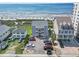 Aerial view of condos, homes, parking lot, and the beach with the ocean in the background at 4105 S Ocean Blvd. # 102, North Myrtle Beach, SC 29582