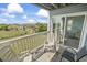 Balcony with chairs offering serene ocean views, perfect for relaxation at 4105 S Ocean Blvd. # 102, North Myrtle Beach, SC 29582