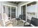 View from balcony into living room with beachy decor, lots of light, and cozy seating at 4105 S Ocean Blvd. # 102, North Myrtle Beach, SC 29582